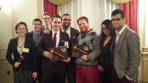 The Head Delegates for the University of Chicago (right) and Florida International University (left) pose for a picture with their Large Delegation awards. 