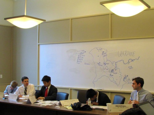 Delegates analyze a detailed map of the contested region provided by the Ad-Hoc crisis staff. 